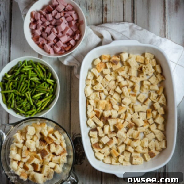 Chopped ham and asparagus, key ingredients for a savory make-ahead strata breakfast casserole.