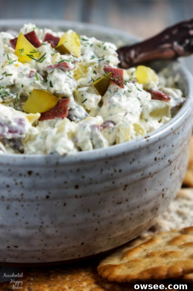 A bowl of creamy Pickle Thing Dip, ready to be served at a party.