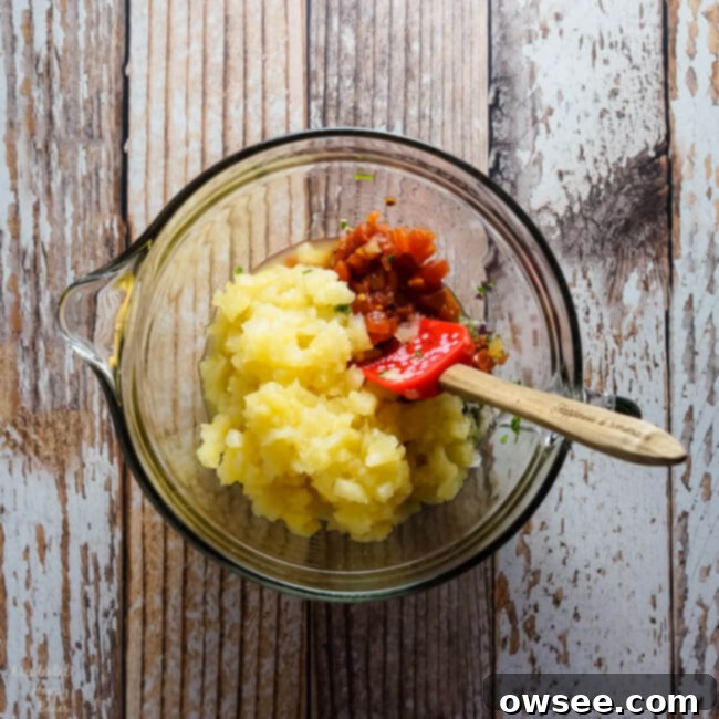 Close-up of freshly made pineapple salsa in a bowl with a spoon.