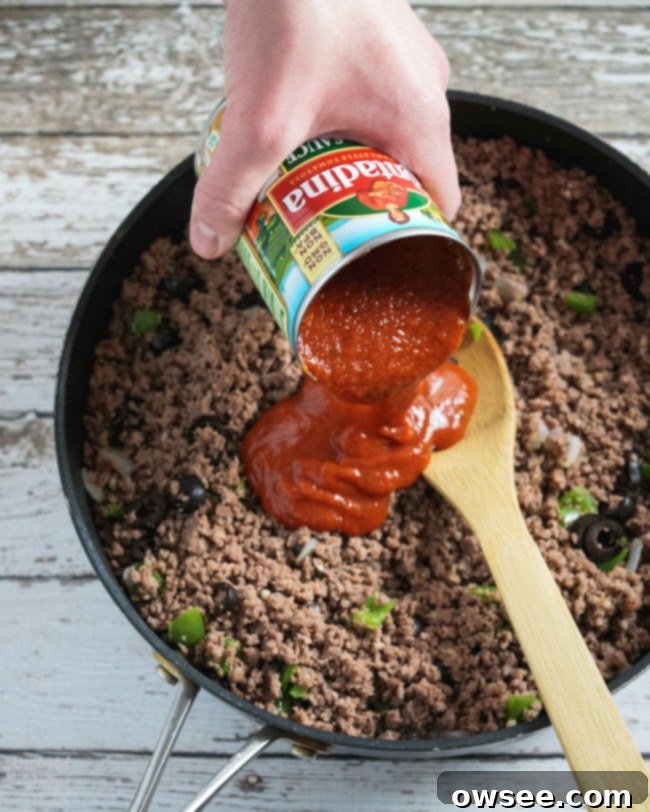 Pizza Sauce is added to the ground beef mixture, creating a rich Italian sloppy joe filling.