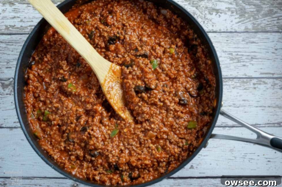 A pan of Italian Sloppy Joe filling, rich with meat, vegetables, and sauce, ready to be spooned onto the buns. 
