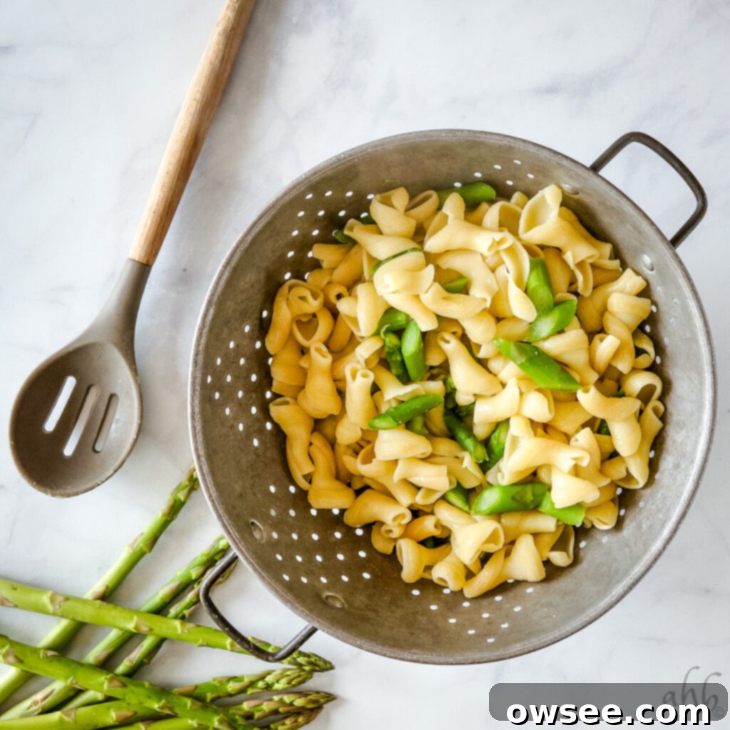 Rich Pesto Pasta Delight 3 A bowl of fresh, green asparagus stalks, ready for preparation.