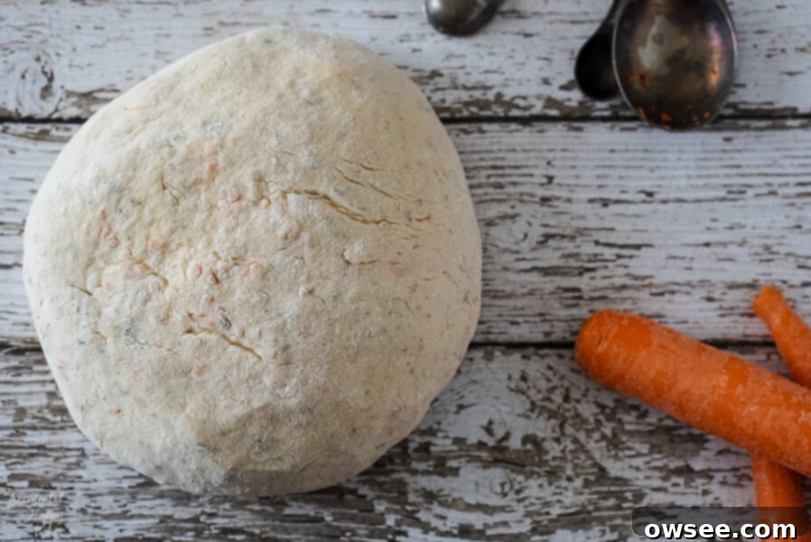 Carrot and chive bread dough after kneading, showing a smooth and elastic texture.