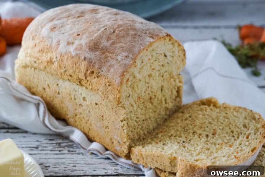 A freshly baked loaf of carrot and chive bread, just sliced and ready to serve.