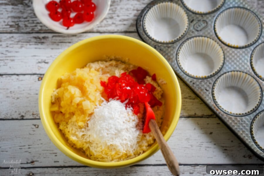 Malibu Dream Muffins 3 A vibrant yellow mixing bowl filled with ready-to-bake muffin batter sits next to a prepared muffin tin, showcasing the ease of the Malibu Muffins recipe.