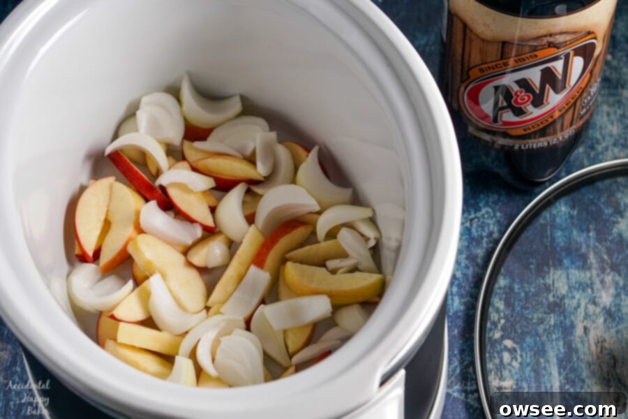 Caramelized Root Beer Pulled Pork 3 Thick slices of fresh apples and sweet onions are layered evenly at the bottom of a slow cooker before adding the pork.