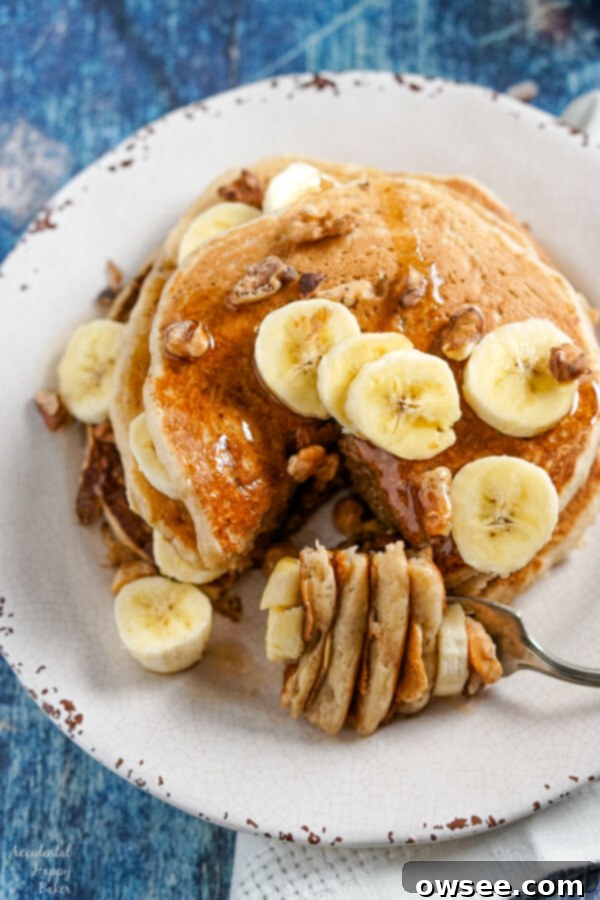 Light and fluffy banana pancakes have the taste of banana bread baked inside to make an easy breakfast treat your whole family will love. #bananapancakes #pancakerecipe #breakfast #brunch #pancakes #accidentalhappybaker