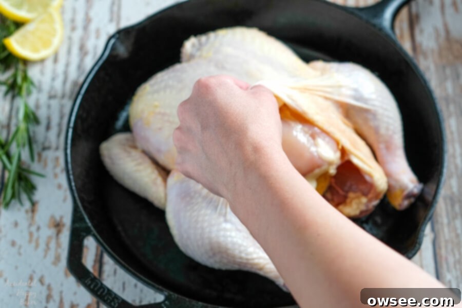 Perfectly Roasted Chicken 5 Prepping the raw chicken by gently separating the skin from the breast.