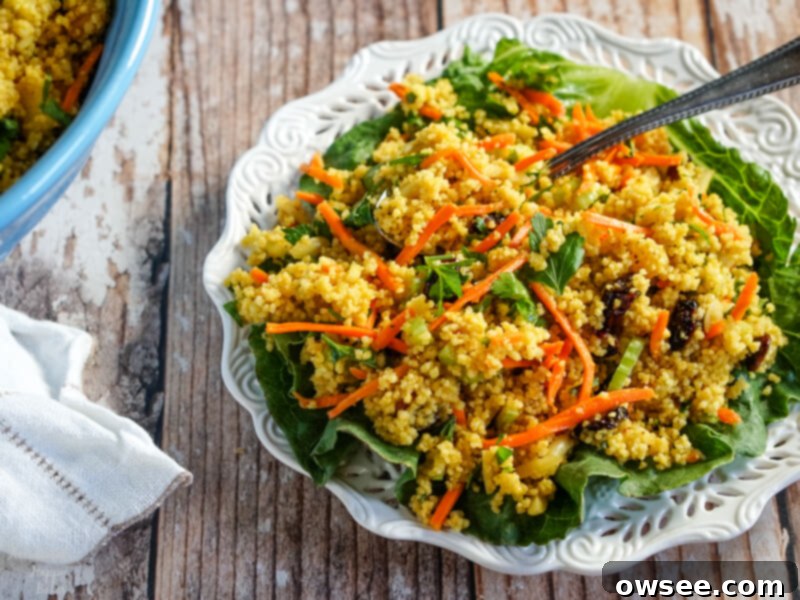 Sunshine Couscous Salad 6 A serving plate of curried couscous salad served on a fresh lettuce leaf, ready to be enjoyed.