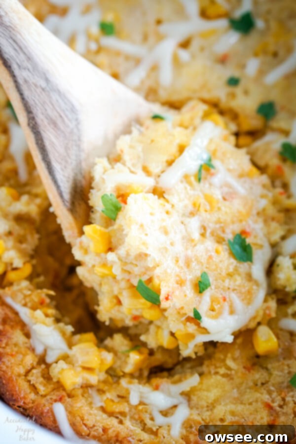 Close-up shot of the creamy and cheesy Crock Pot Corn Casserole, showing bits of sweet corn and the lovely texture created by the cornbread mix.