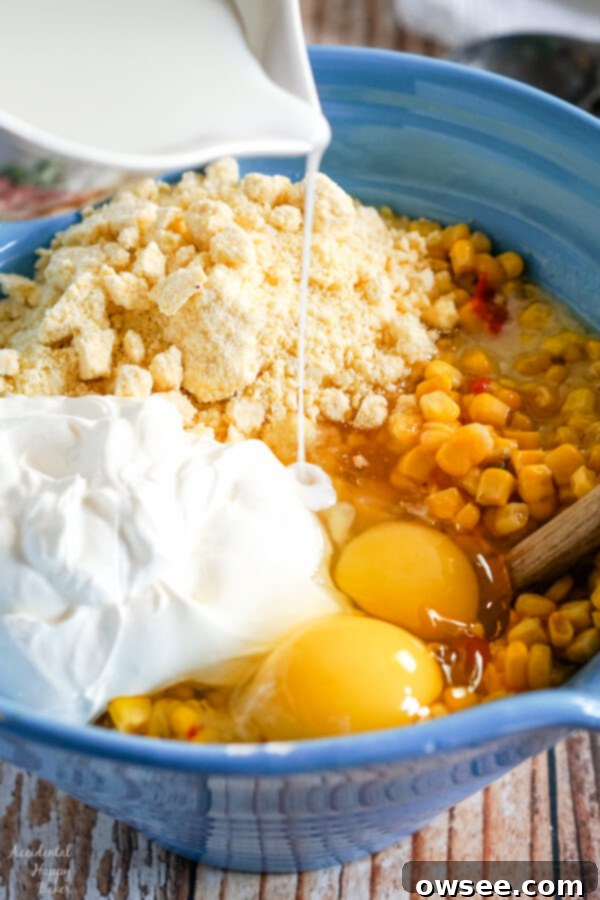 A close-up of Crock Pot Corn Casserole baking in a slow cooker, showing its bubbling edges and creamy texture, nearly ready to be served.