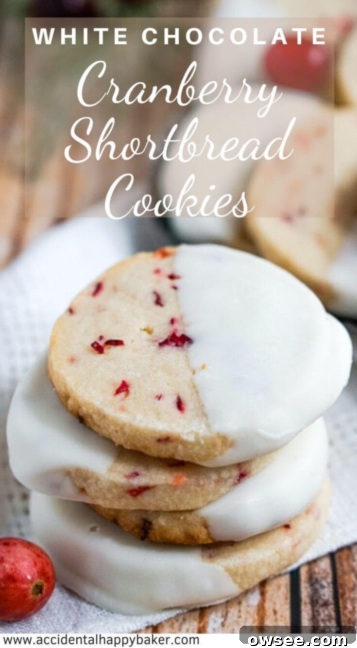 White Chocolate Cranberry Shortbread Cookies have fresh chopped cranberries, a buttery crisp texture, and are dipped in white chocolate. #christmascookies #cranberrycookies #shortbreadcookies