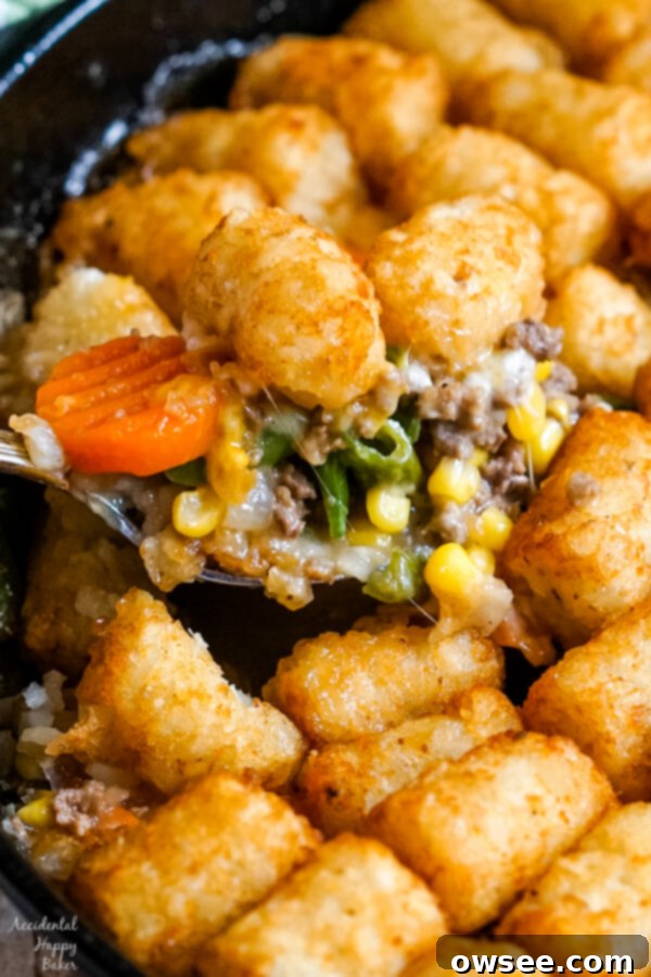 Tater Tot Shepherds Pie 7 A spoonful of Shepherd's Pie with Tater Tots is scooped out of the skillet.