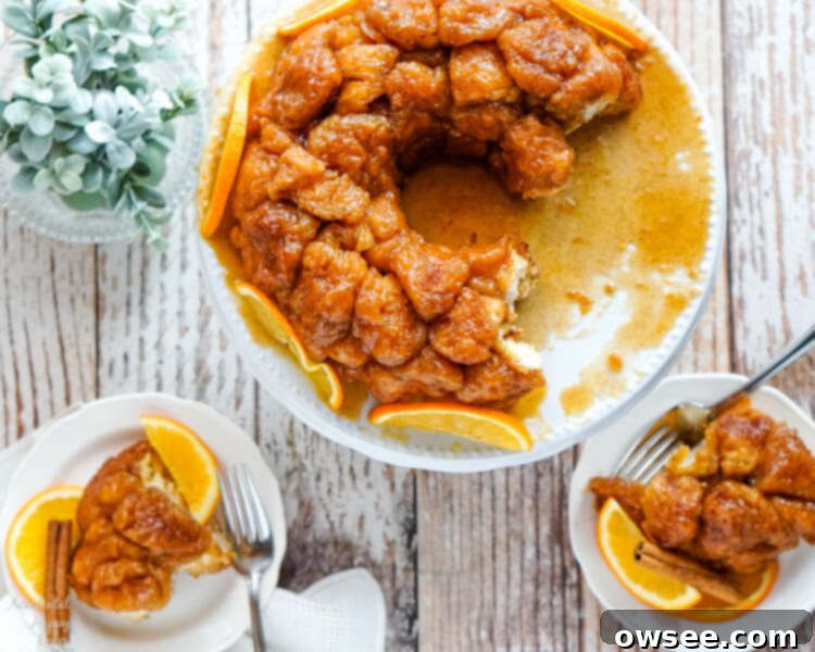 A large serving plate of Orange Spiced Monkey Bread and 2 small plates with servings. 