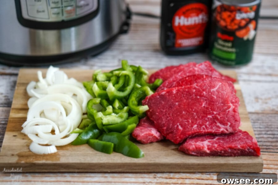 Tender Instant Pot BBQ Swiss Steak 4 Onions, peppers, and steaks sitting in front of the Instant Pot with bbq sauce and tomatoes in the background.