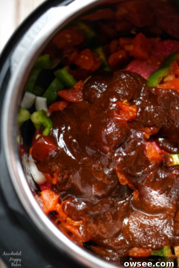 Tender Instant Pot BBQ Swiss Steak 6 Barbecue sauce is added to the instant pot.