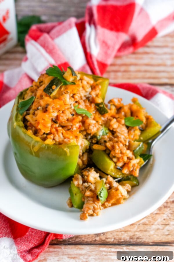 Hearty Wild Rice Stuffed Peppers 7 A wild rice stuffed pepper that has been cut open, revealing the savory filling.