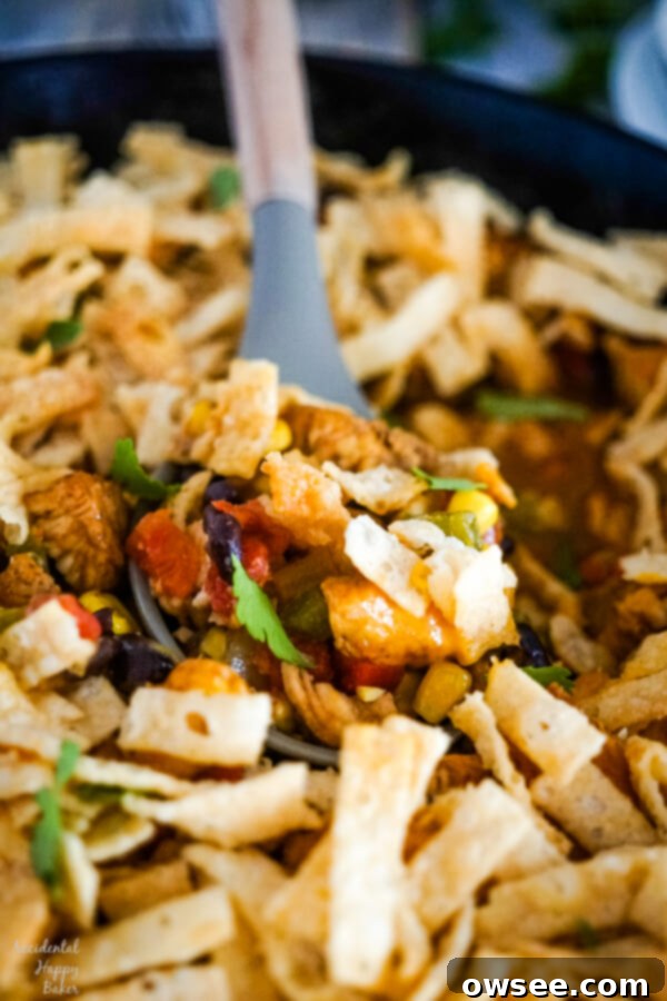 Southwestern Egg Roll Chicken Bake 8 Scooping out a spoonful of Southwestern Egg Roll Bake