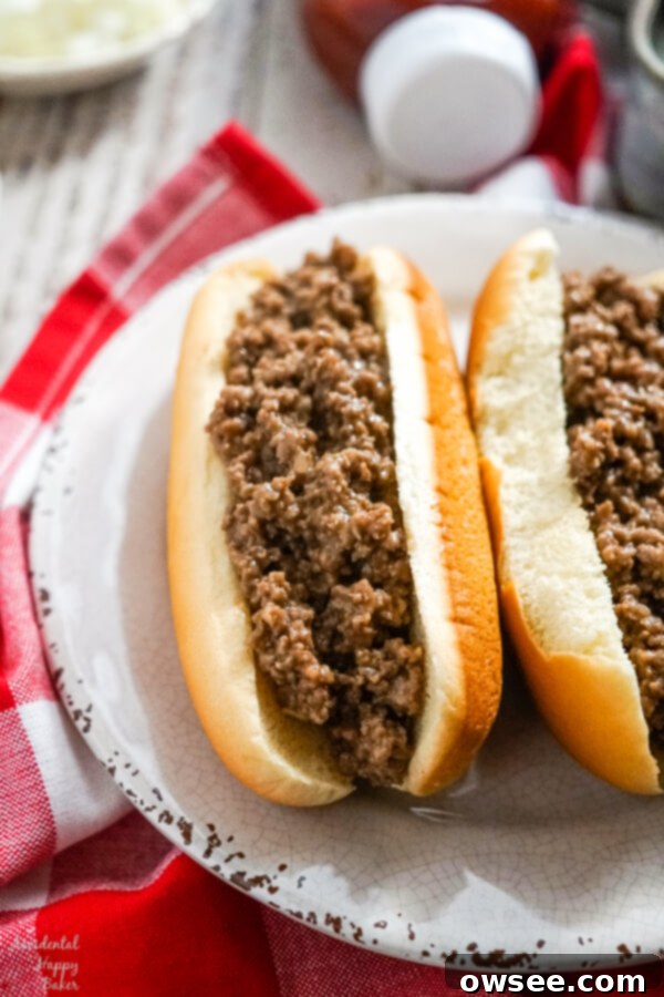 Two loose meat sandwiches on a white plate.