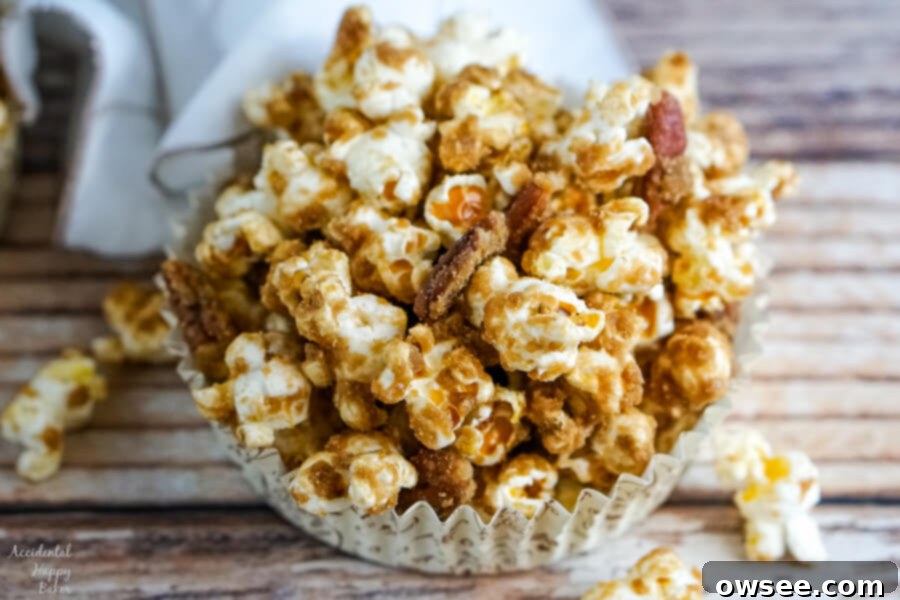 Decadent Salted Caramel Pecan Popcorn 9 A paper cup with a serving of Salted Caramel Pecan Popcorn