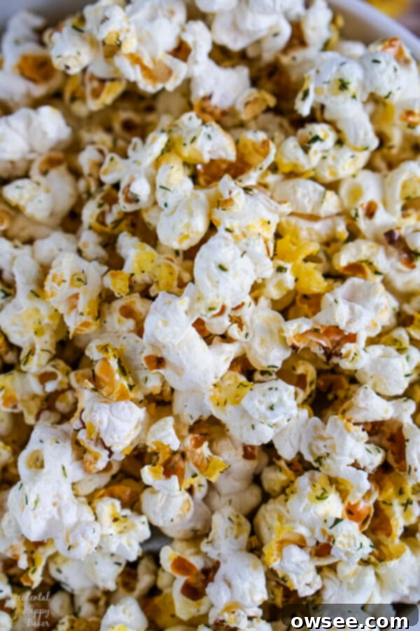 A detailed close-up image showing the appealing textures and perfectly distributed seasonings on dill pickle popcorn kernels, emphasizing its homemade quality.