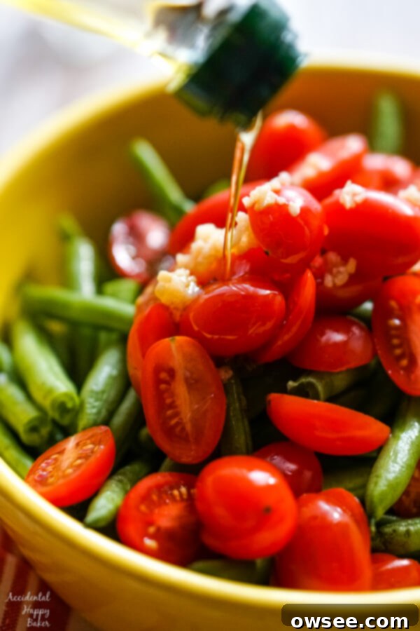 A close up showing olive oil drizzled over the vegetables. 