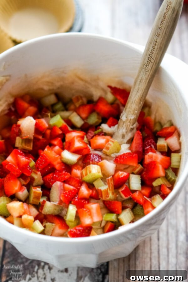 Fold in the chopped strawberries and rhubarb into the muffin batter.