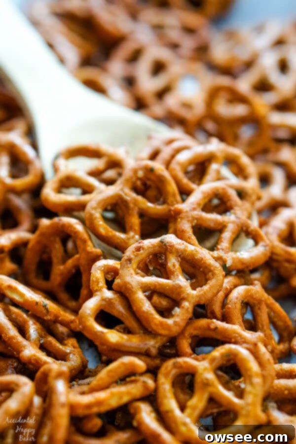 A wooden spoon scooping up some pretzels.