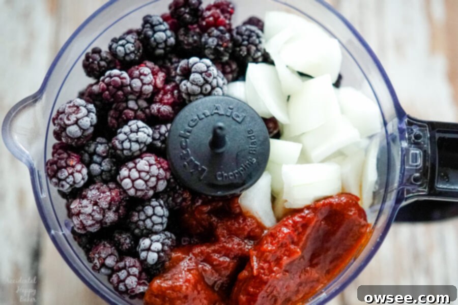Artisan Blackberry Barbecue Sauce 4 Blackberries, onion, and chipotle peppers are added to the food processor, ready for blending.