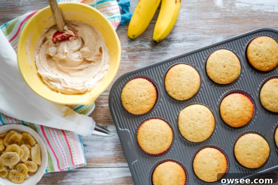 Banana Peanut Butter Bliss Cupcakes 4 A bowl of peanut butter frosting and a bowl of banana chips next to a pan of cupcakes ready to be frosted and decorated.