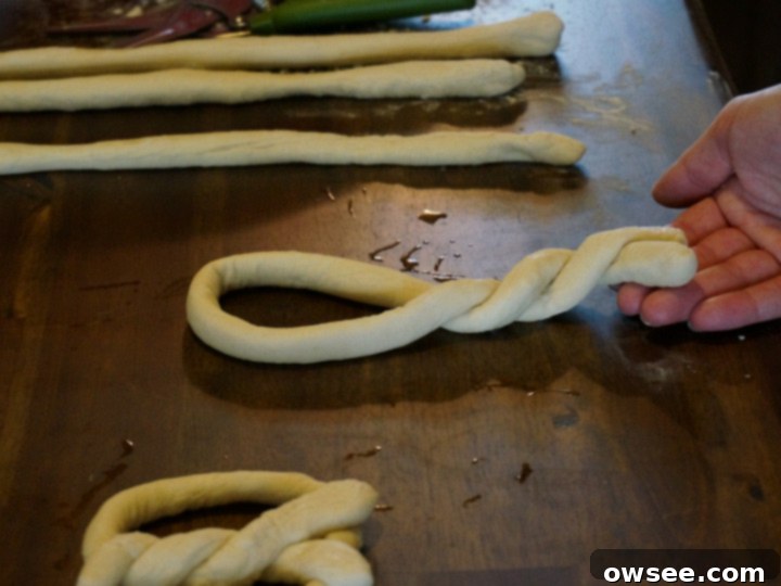 Asiago cheese being sprinkled onto soft pretzels