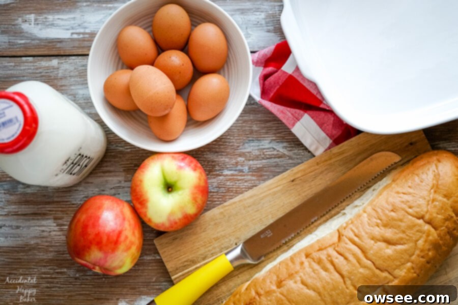 The core ingredients for this Cinnamon Apple French Toast Casserole are a loaf of crusty bread, fresh apples, eggs, and rich whole milk.