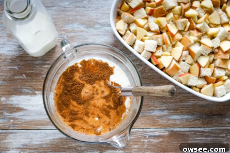 A mixing bowl filled with whole milk, eggs, cinnamon, and sugars, perfectly blended and ready to be whisked into a luscious custard.