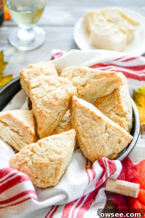 Savory White Cheddar Scones 11 A pan full of white cheddar scones with a glass of wine in the background