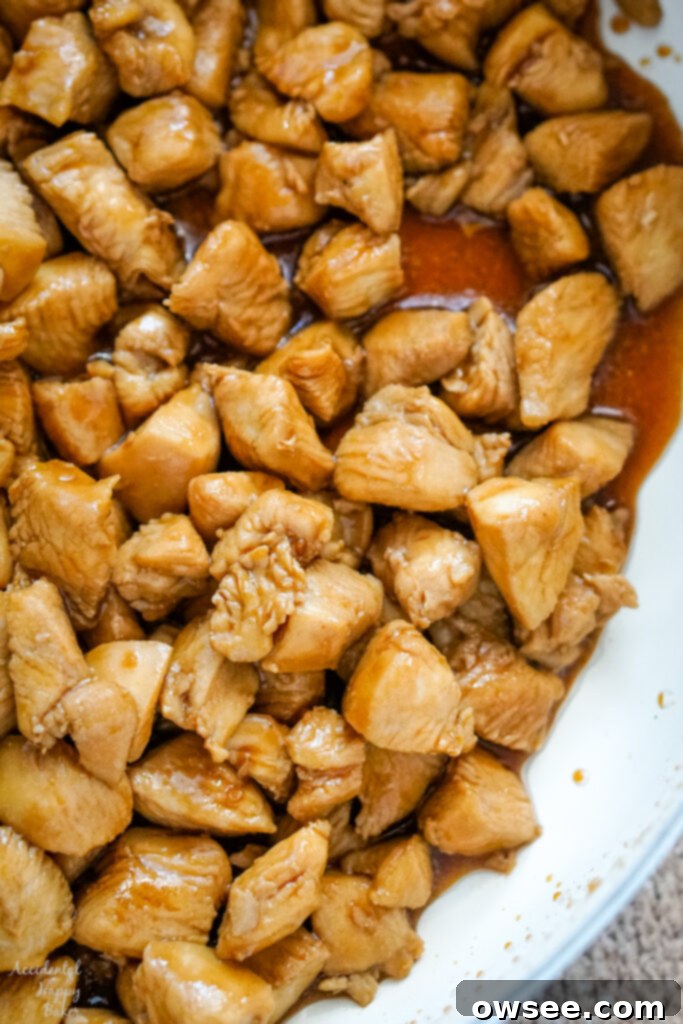 Crispy Wonton Chicken Taco Salad 5 Diced marinated chicken browning beautifully in a hot skillet, creating a delicious caramelization on its surface.