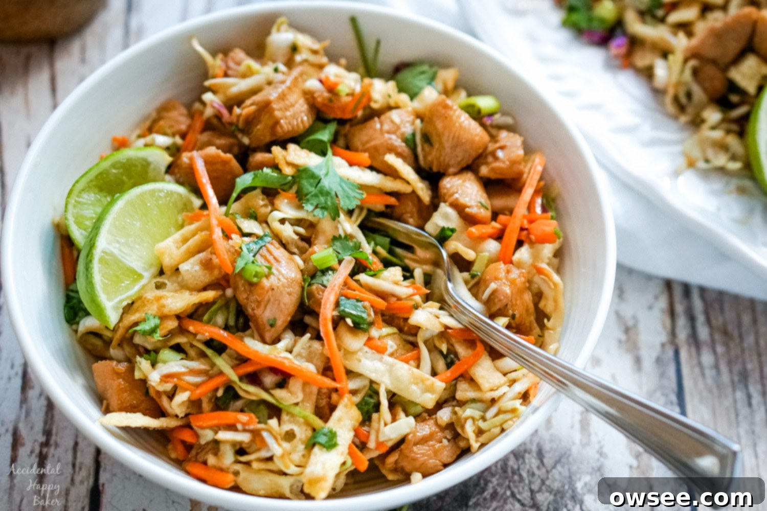 Crispy Wonton Chicken Taco Salad 8 A delicious bowl of Wonton Chicken Taco Salad, garnished with fresh lime, showcasing the vibrant ingredients.