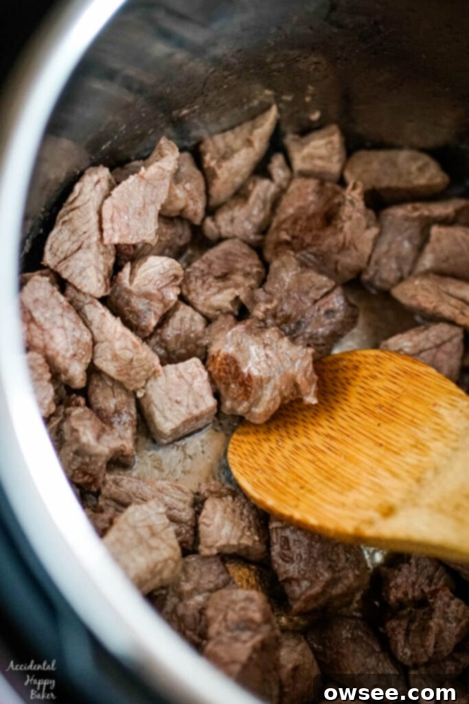 Effortless Instant Pot Beef Stew 3 Cubed stew beef is browned in oil in the instant pot.