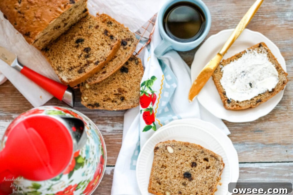 Bara Brith Traditional Welsh Tea Bread 2 A loaf of sliced Bara brith bread next to a cup of tea, a kettle, and slices of Welsh tea bread.