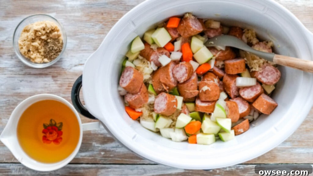 Hearty Slow Cooker Kielbasa and Sauerkraut Dinner 5 Sauerkraut, kielbasa and chopped veggies are added to the slow cooker.