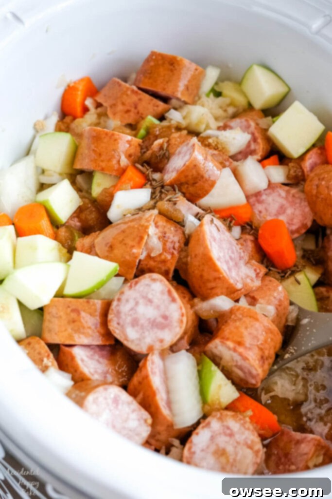 Hearty Slow Cooker Kielbasa and Sauerkraut Dinner 6 The brown sugar, caraway seeds and apple juice are poured over the top.