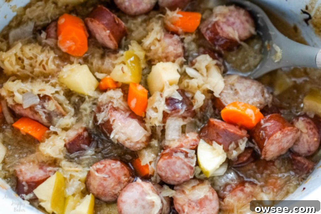 Hearty Slow Cooker Kielbasa and Sauerkraut Dinner 7 A crockpot of cooked kielbasa and sauerkraut.