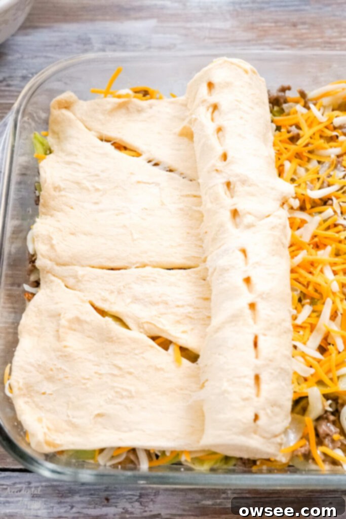 Hearty Runza Casserole 4 Rolling the crescent roll dough over the filling for the Runza casserole