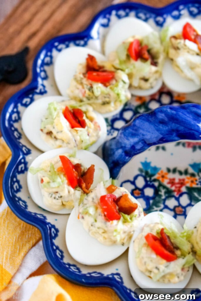 Next-Level BLT Deviled Eggs 2 A close up image of BLT deviled eggs arranged on an egg plate.