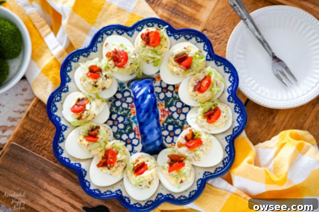 Next-Level BLT Deviled Eggs 3 A plate of BLT deviled eggs on a wooden serving tray.
