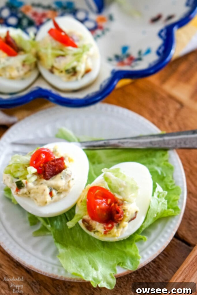 Next-Level BLT Deviled Eggs 7 Two BLT deviled eggs on a bed of lettuce.