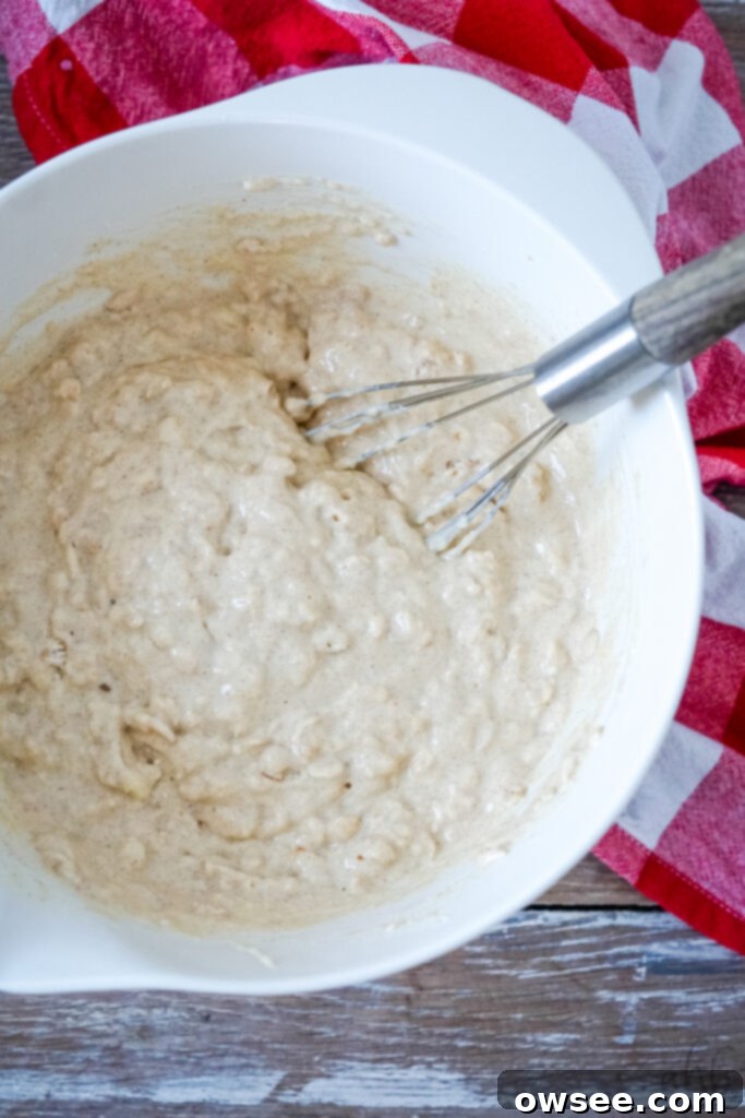 Homestyle Oatmeal Waffles 6 Wet and dry ingredients combined in a bowl for oatmeal waffle batter.