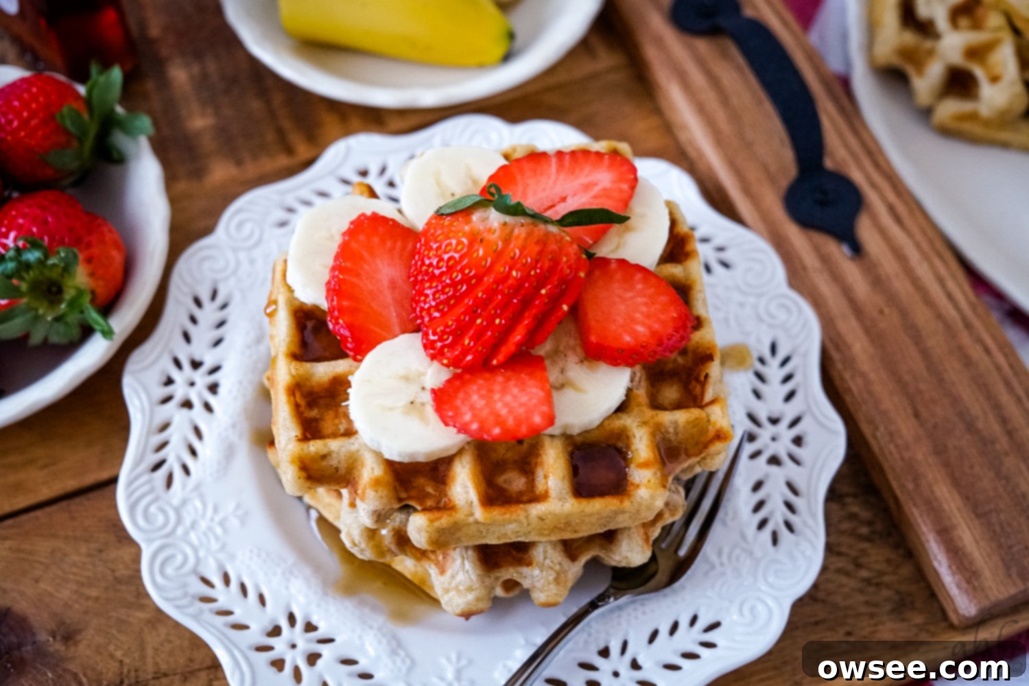 Homestyle Oatmeal Waffles 9 A stack of perfectly golden old-fashioned oatmeal waffles on a white plate, ready to be served or frozen.