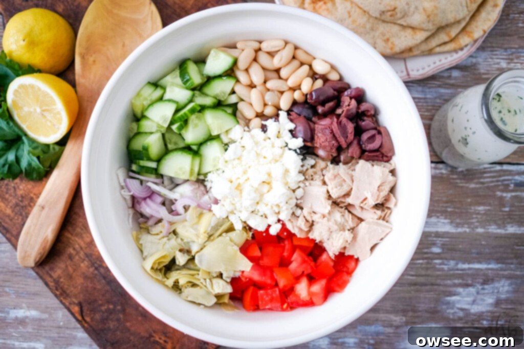 Creamy Mediterranean Tuna Salad 5 All of the fresh and canned ingredients for the Mediterranean tuna salad arranged in a large serving bowl, ready to be combined.