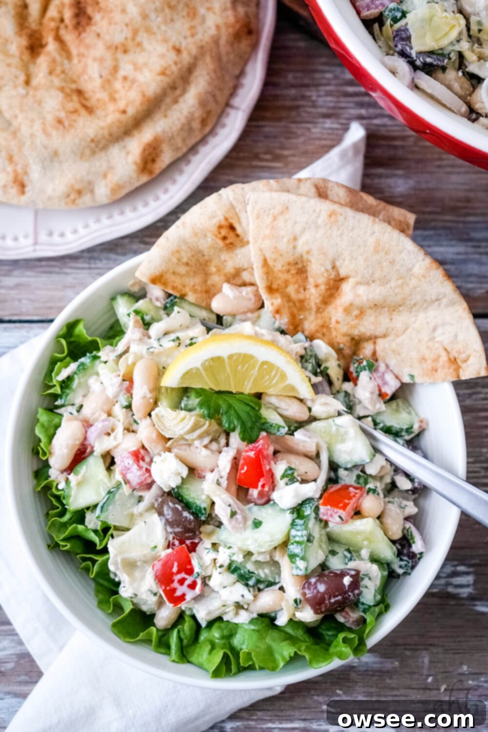 Creamy Mediterranean Tuna Salad 6 A serving of Mediterranean Tuna Salad with Pitas to one side, ready to be enjoyed.