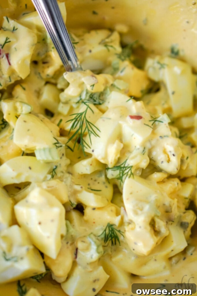 A close up image of a bowl of homestyle egg salad.